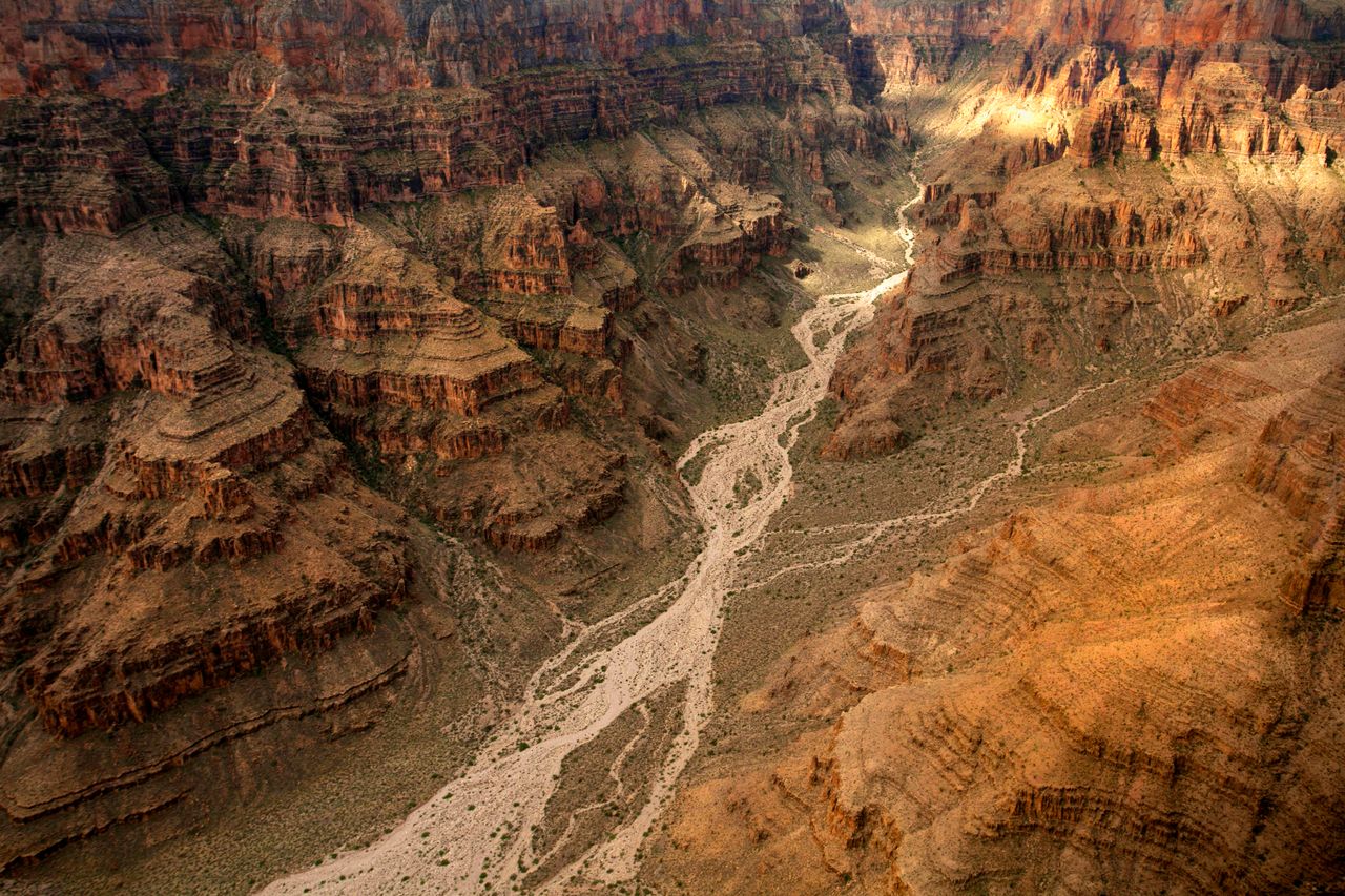 Stunning aerial view of the Grand Canyon's dramatic cliffs and winding river channels.